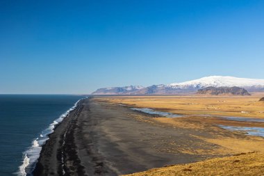 Boş gökyüzü, soğuk ve rüzgarlı Dyrholaey yarımadasında Mart günü