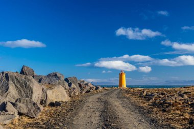 Soğuk bir yürüyüş gününde İzlanda sahilindeki deniz feneri.