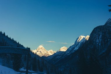 Frosty winter sunset in Tarvisio, Friuli Venezia Giulia, Italy clipart