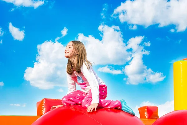 Happy Smiling Little Girl Having Lots Fun Inflate Castle While 免版税图库图片