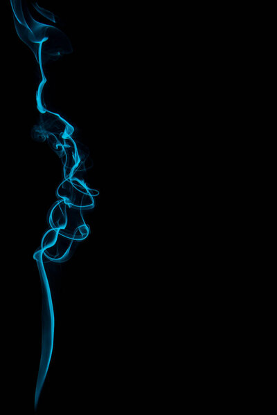 Abstract turquoise smoke swirl trail on black background.