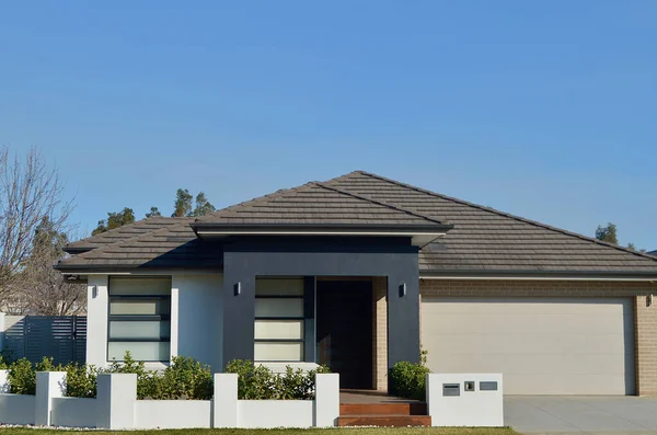 stock image A view of a modern home in the suburbs on a sunny afternoon