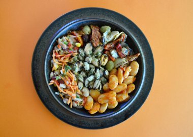 Smoked mussels with Greek gigantes beans antipasto and bean salad on a plate.  clipart