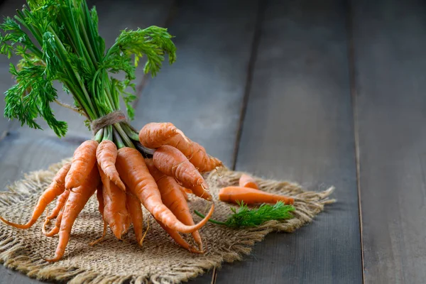 Fresh Baby carrots on wood background, High Beta Carotene and help the body have immunity against colds. Prevent cancer and diseases related to bone, skin and eyes