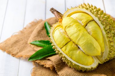 Durian meyvesi. Çuvalda olgun monthong durian ve beyaz ahşap arka plan, Tayland 'ın yaz mevsiminde meyve kralı