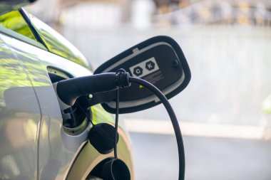 EV, sürdürülebilir kaynaktan CO2 emisyonunu azaltmak için şarj istasyonuna kadar sürdürülebilir kaynaktan üretilen yeşil enerji ve eko gücü kavramına göre elektrikli araba için evde şarj ediliyor