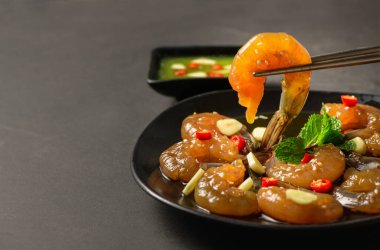 Pickled shrimp with chopstick Soy Sauce, chilli and garlic on stone background, korean food clipart