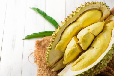 Durian meyvesi. Çuvalda olgun monthong durian ve beyaz ahşap arka plan, Tayland 'ın yaz mevsiminde meyve kralı