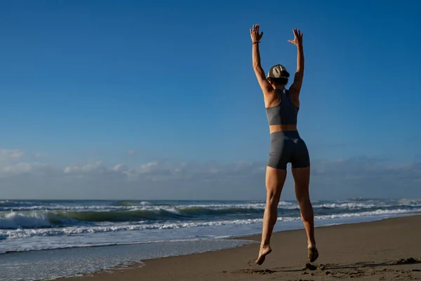 stock image beautiful young girl goes in for sports on the seashore does dif