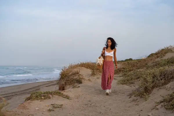 stock image Young Woman Walking on a Sandy Path by the Beach