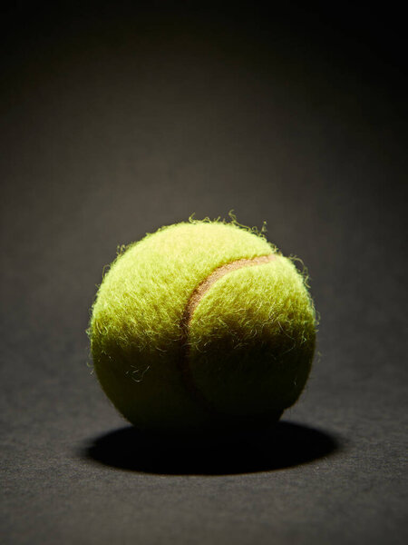 Tennis ball on black background with copy space for your text.
