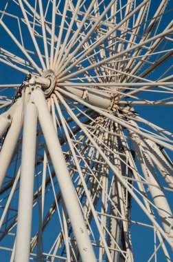 The axis of rotation of a white Ferris wheel close u