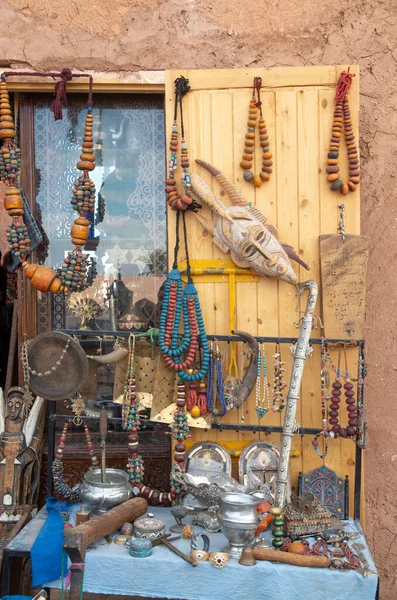 Traditional moroccan souvenirs jewels, african masks and hand of Fatima in street market in Ait Ben Haddou, Morocc