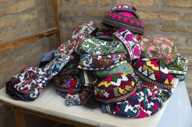 Many colorful handmade skullcaps closeup in bazaar in Uzbekistan, Asi clipart