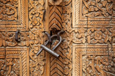 Khiva 'da, Özbekistan, Asi' de eski bir asma kilidi olan ahşap kapıya eski bir oyma.