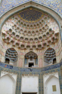 Impressive entrance of Abdulaziz Khan Madrasah on arch and decoration of ceramic mosaics, stalactites, and geometric ornaments in Bukhara , Uzbekistan, Asi clipart