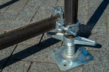 Geçici yapının kapanması için yeni bir çift iskelet kelepçesi ve yapı iskelesi boruları.