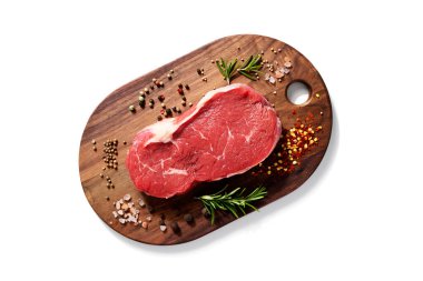Fresh raw beef steak with spices isolated on white background. top view