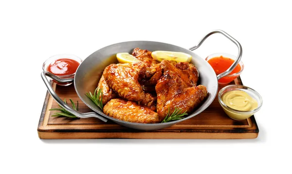 stock image Air fryer chicken wings glazed with hot chilli sauce and served with different sauces.  isolated on white  background .