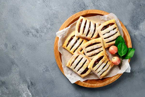 stock image Homemade puff pastry pies filled with caramelized apples . top view