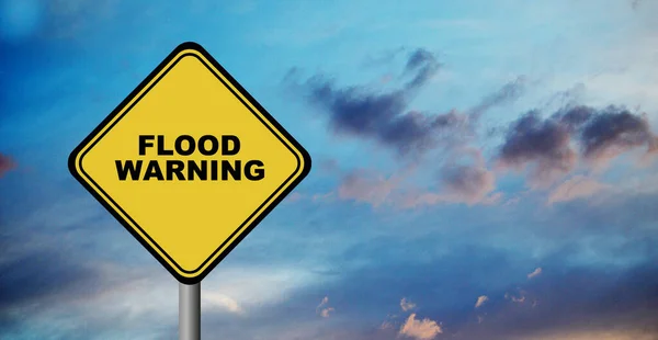 stock image flood warning sign on cloudy sky background