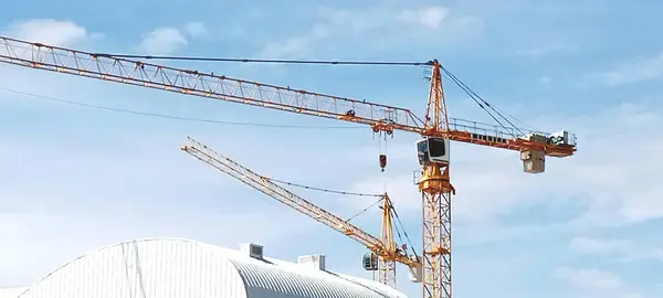 stock image construction crane shot from afar in cloudless sky