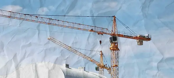 stock image construction crane shot from afar in cloudless sky