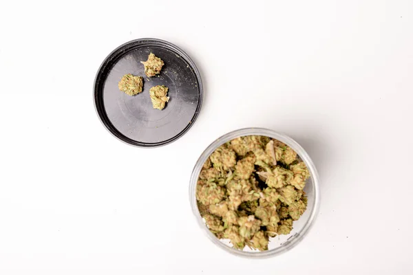 stock image Photo of Jar full of Dry marijuana buds, cannabis dried flowers, medical marijuana, laying on the white table.