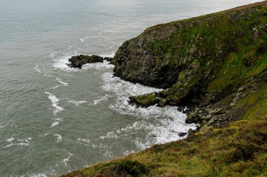Photo of Howth Cliffs, Dublin, Ireland. Cloudy landscape with Ireland coastline and North Sea. Howth Cliffs Walk. clipart