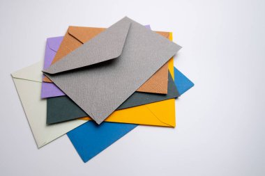 Hafif arka planda kağıt zarflar. Yeni posta, bir mesaj yaz. Gönder ve al. Posta servisi. Boş zarf, boş alan. İnsanlarla iletişim, evrak işleri. Zarfı kapat.