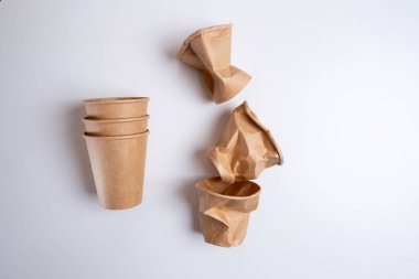 Açık arkaplanda çevre dostu kağıt kahve fincanları. Sıfır atık, plastiksiz ürünler. Tam ve çökmüş camlar. Plastik kirliliğini durdurun. Model