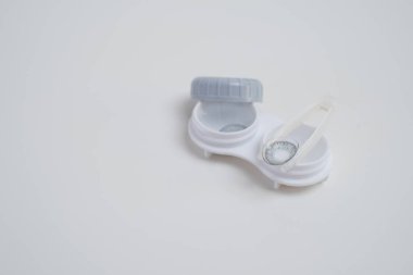 Kontakt lensler, çanta ve solüsyonlu şişe ve beyaz arka planda göz damlası. Göz sağlığı ve bakımı, görüş, göz bilimi konsepti, yakın çekim