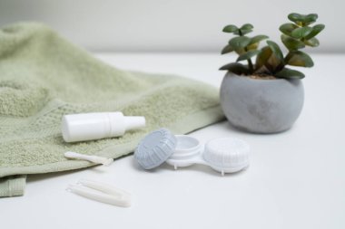 Kontakt lensler, çanta ve solüsyonlu şişe ve beyaz arka planda göz damlası. Göz sağlığı ve bakımı, görüş, göz bilimi konsepti, yakın çekim