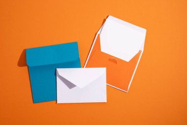 Hafif arka planda kağıt zarflar. Yeni posta, bir mesaj yaz. Gönder ve al. Posta servisi. Boş zarf, boş alan. İnsanlarla iletişim, evrak işleri. Zarfı kapat.