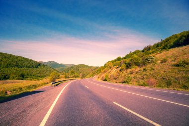 View of the mountain winding highway during sunrise in autumn. Carpathian mountains. Ukraine