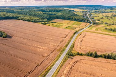 Kırsal alanın havadan görünüşü. Otoyol ve ekili buğday tarlaları tepelerde