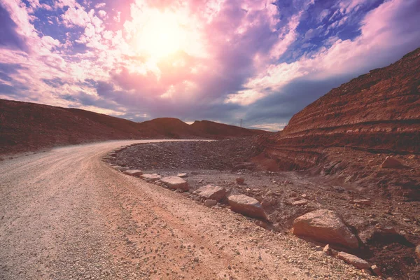 stock image Mountain desert landscape. Dirt road in National Park Makhtesh Ramon Crater in Negev desert, Israel