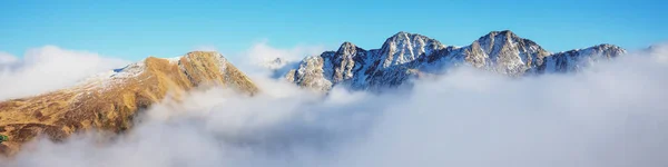 Mountains minimalist landscape. Peaks of the mountains above the clouds. Pyrenees, Andorra, Europe. Horizontal banner