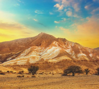 Dağlık çöl renkli bulutlu gökyüzü ile. İsrail Yahudi çölde gün batımında
