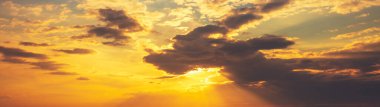 Colorful cloudy sky at sunset. Sky texture. Abstract nature background. Horizontal banner