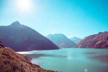 View from above on the shore of a mountain lake in autumn. Klnbreinspeicher, Gamskarnock, Austria Europe clipart