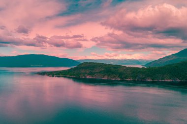 Fjord at sunset. Rocky coast in the evening. Hardanger Fjord. Beautiful nature of Norway clipart