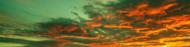 Colorful dramatic cloudy sky at sunset. Gradient color. Sky texture, abstract nature background. Horizontal banner