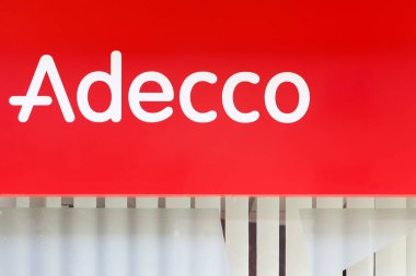 Belleville, France - September 29, 2024: Adecco logo on a wall. Adecco Group, based near Zurich, Switzerland, is the largest staffing firm in the world clipart