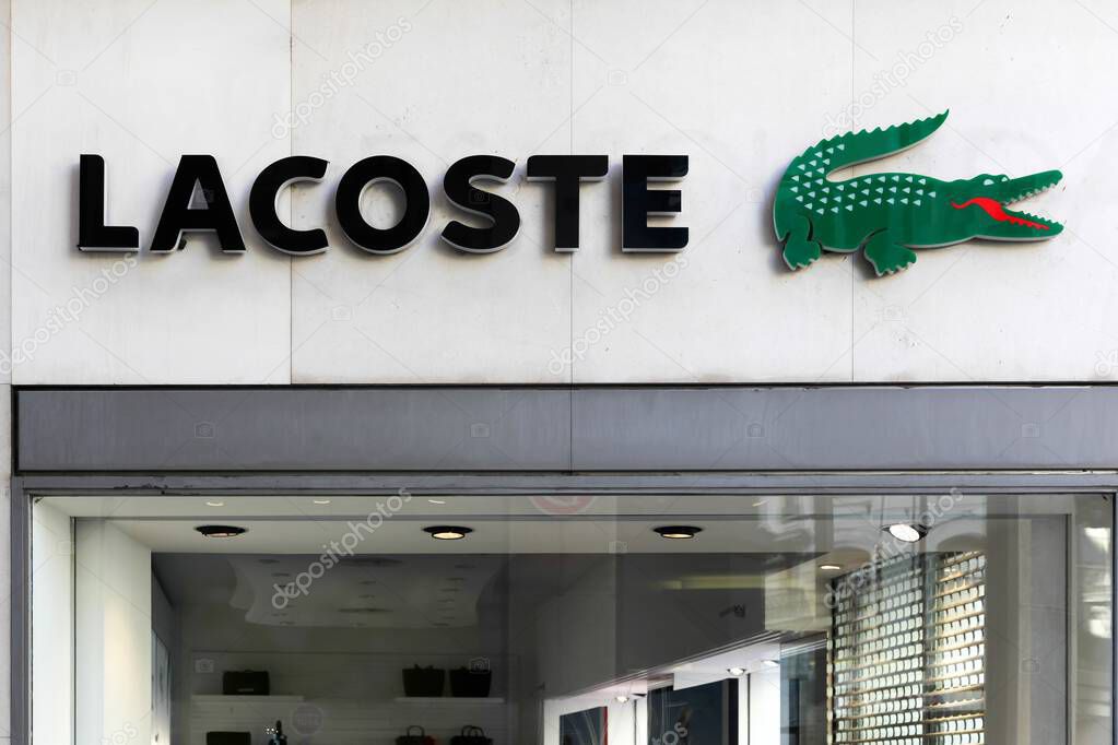 Geneva, Switzerland - August 14, 2016: Lacoste logo on a wall. Lacoste is a French clothing company, founded in 1933 by tennis player Rene Lacoste