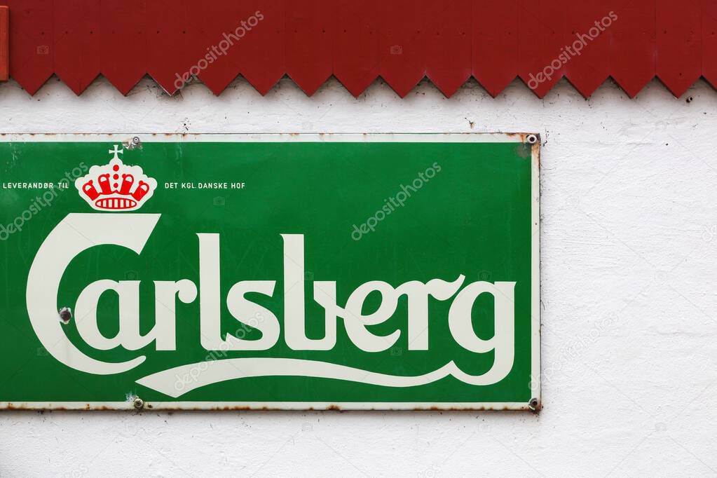 Randbol, Denmark - February 7, 2025: Old advertising of Carlsberg on a wall. Carlsberg Group is a Danish brewing company founded in 1847 with headquarters located in Copenhagen