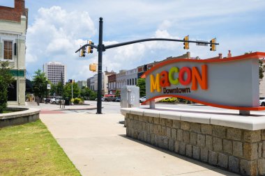 Macon, Georgia USA - June 16, 2023: Cityscape scene with welcome sign in the historic downtown district clipart