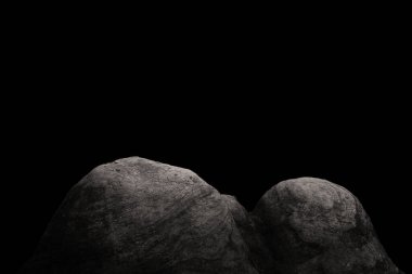 Stone podium on dark black background.	