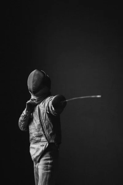 black and white photo of a man with a foil rapier sword