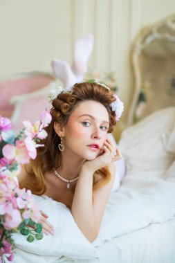 beautiful bride with makeup and hairstyle in a white dress